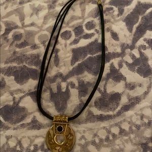 Gold necklace with black stone.